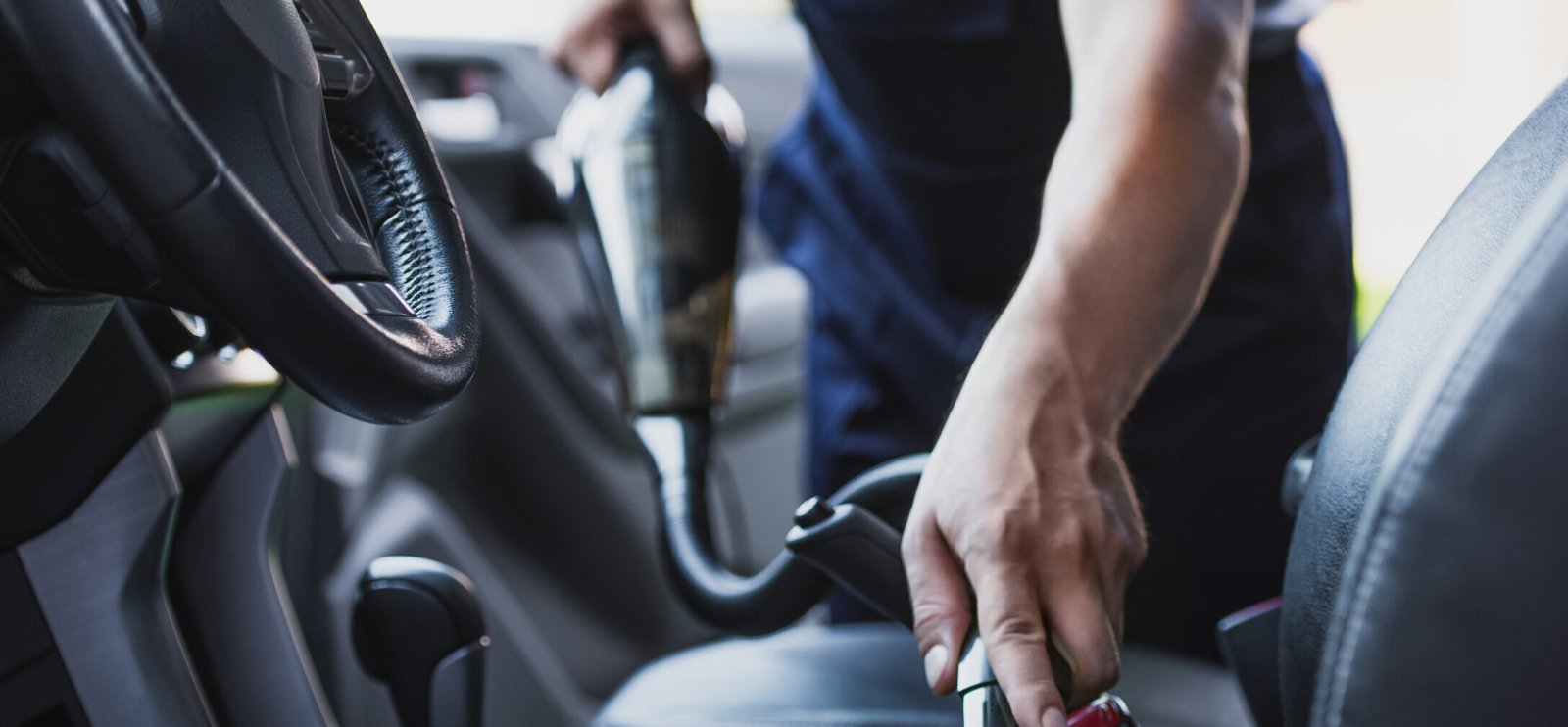 cropped view of car cleaner vacuuming drivers seat 2024 11 18 22 39 23 utc scaled e1738236670948